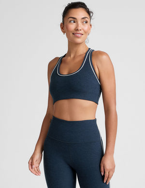 blue scoop neck racerback bra with white contrast trim. 
