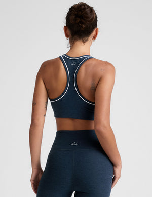 blue scoop neck racerback bra with white contrast trim. 
