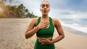 model in green racerback bra and green high-waisted midi biker shorts. 